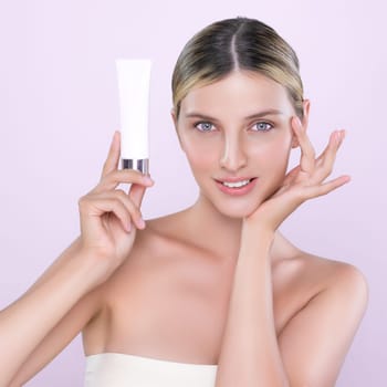 Alluring beautiful perfect cosmetic skin woman portrait hold mockup tube cream or moisturizer for skincare treatment, anti-aging product in isolated background. Natural healthy skin model concept.