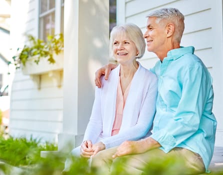 Taking in the summer day. an affectionate senior couple sitting outside on their porch during the summer