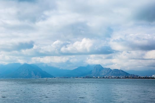 Sea view of the mountains and the city on the horizon. Antalya, Turkiye