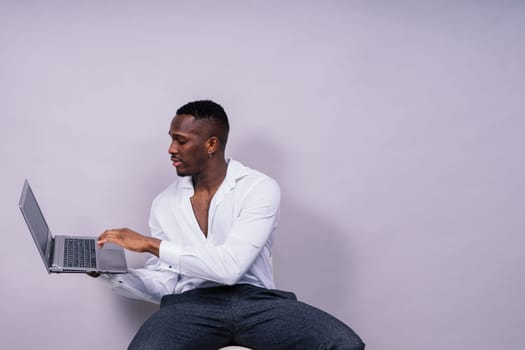 African American millennial businessman isolated on a studio background, successful male formal suit