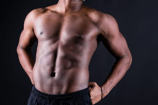 Muscular black african man with muscles abs abdominal, exercise determination and success