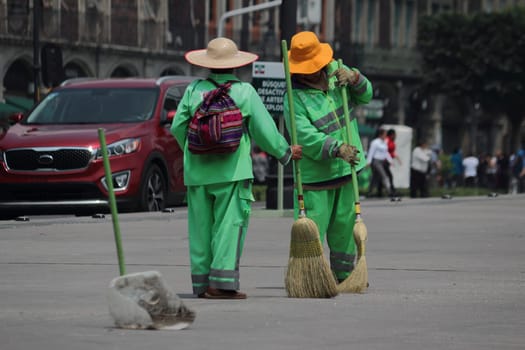 Mexico City Mexico - October 2019 Street sweeper during his work day in the pinth of the city. Mexicans do not have a culture of cleaning and this job may be very hard in big cities like this.