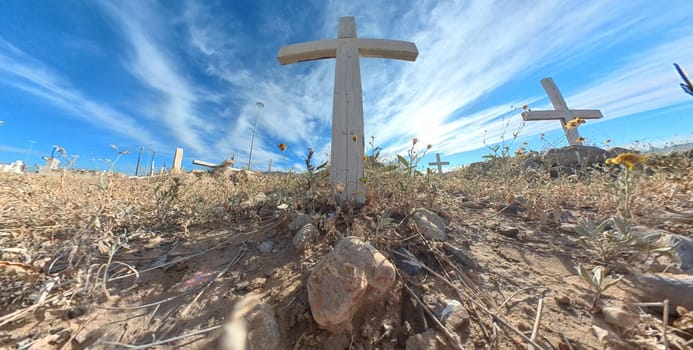 Wooden cross at cemetery with stripped sky background focus to soft focus