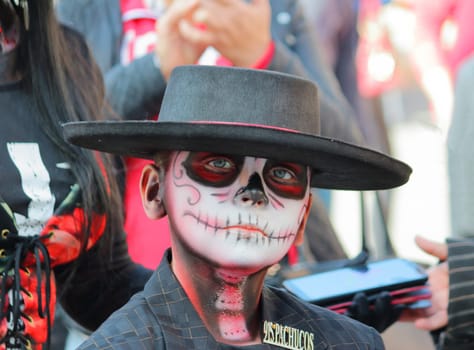El Paso, Texas, November 4, 2019. Boy posing with Mexican traditional clothes and make-up, during dia de los muertos, day of the dead.