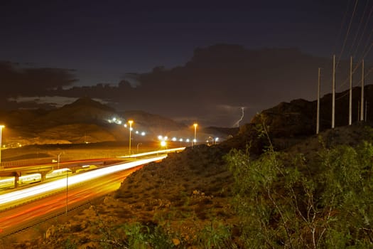 Lightning storm over asphalt road taken at long exposure