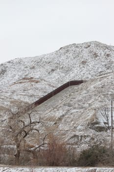 Border wall covered in snow in the mountains in El Paso.