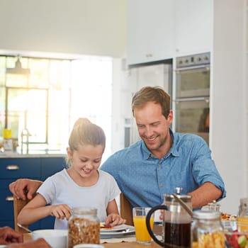 She knows the meaning of true love. a little girl enjoying breakfast with her father