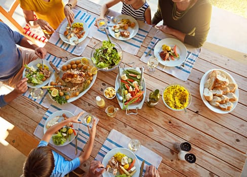 This is what family time is all about. a family enjoying a meal together at home