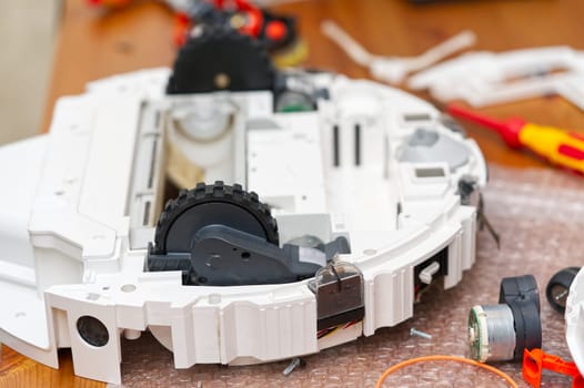 Repair of the robot vacuum cleaner. Disassembled robot vacuum cleaner. home electronics repair concept