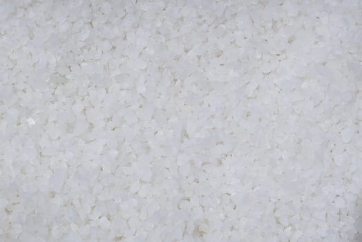 Background from white sea salt. Coarse rock salt texture.