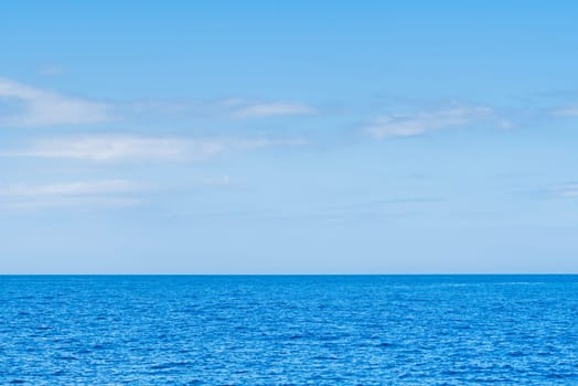 Blue sea and white clouds on sky. Water cloud horizon background. Feeling calm, cool, relaxing. The idea for cold background and copy space on the top. the ocean deep indigo