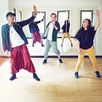 When the beat drops...rise. a group of young people dancing together in a studio