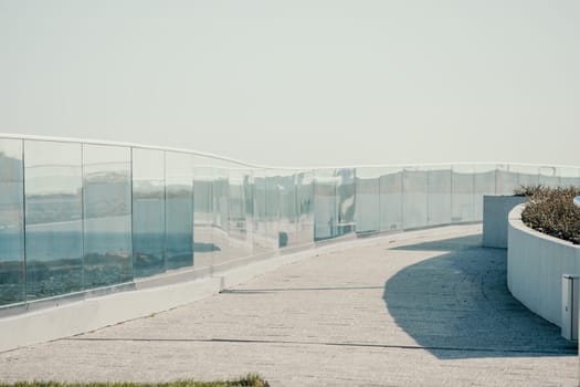 Panoramic view of the city. An observation deck with a figured fence and a lantern. City view.