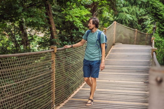 Man tourist in Rope bridge in Yildiz Park. Besiktas, Istanbul, Turkey. Turkiye.