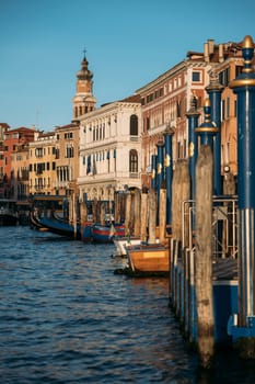 Vertical shot of scenic location in Venice with old houses and canals on a sunny spring day. Concept of honeymoon trip or tourism in Italy. Copyspace.