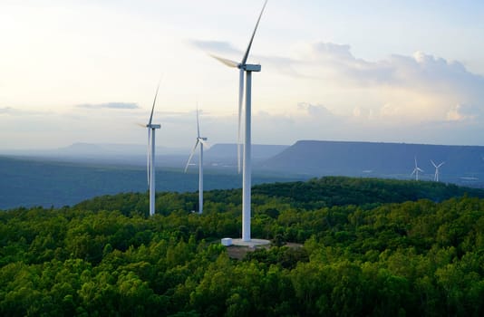 Wind energy. Wind power. Sustainable, renewable energy. Wind turbines generate electricity. Windmill farm on mountain with sunset sky. Green technology. Renewable resource. Sustainable development.