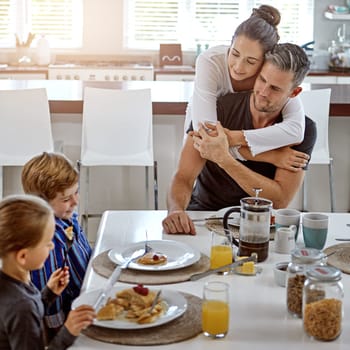 Eating together as a family has multiple benefits. a family having breakfast together