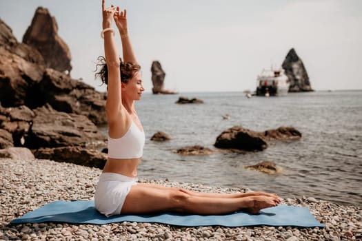 Woman sea yoga. Back view of free calm happy satisfied woman with long hair standing on top rock with yoga position against of sky by the sea. Healthy lifestyle outdoors in nature, fitness concept.