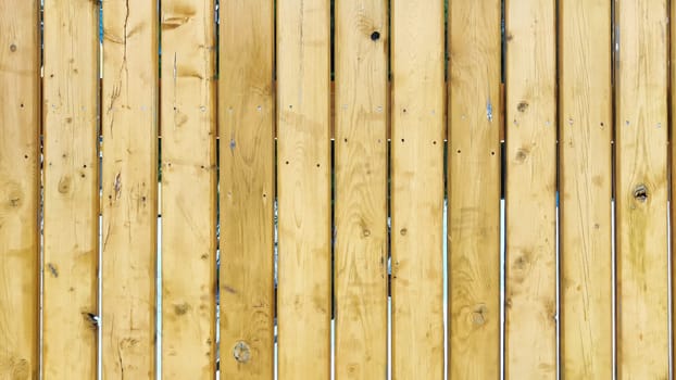 Fence made of wooden slats as Location, Background, texture, copy of space, frame. Abstract natural graphic resource