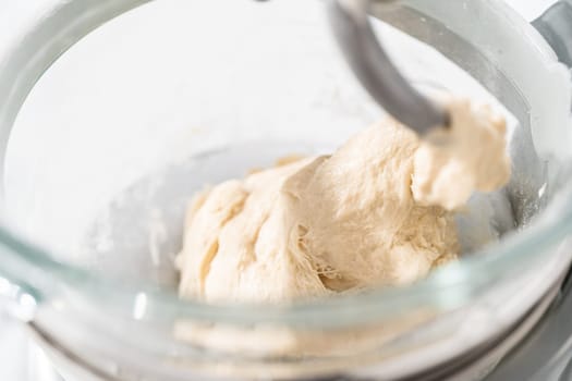 Mixing bread dough in a stand-alone kitchen mixer to bake patriotic cinnamon twists.