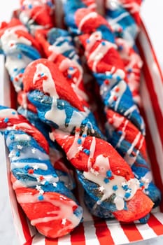 Patriotic cinnamon twists drizzled with a white glaze and decorated with star sprinkles.