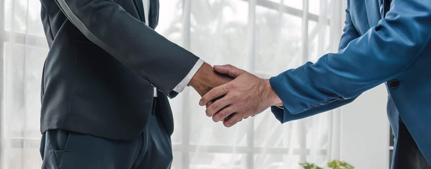 Business handshake for teamwork of business merger and acquisition,successful negotiate,hand shake,two businessman shake hand with partner to celebration partnership and business deal concept