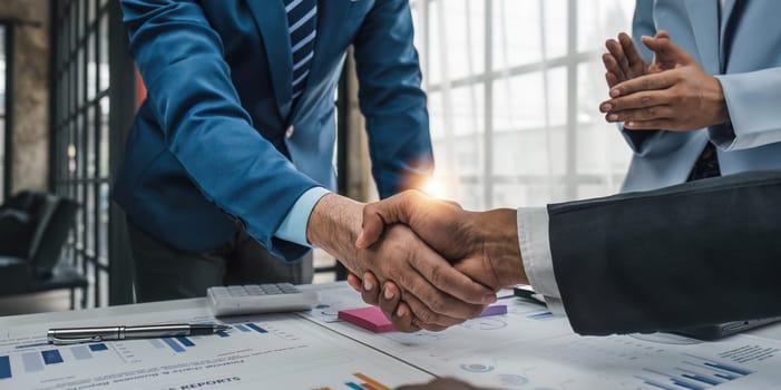 Business handshake for teamwork of business merger and acquisition,successful negotiate,hand shake,two businessman shake hand with partner to celebration partnership and business deal concept