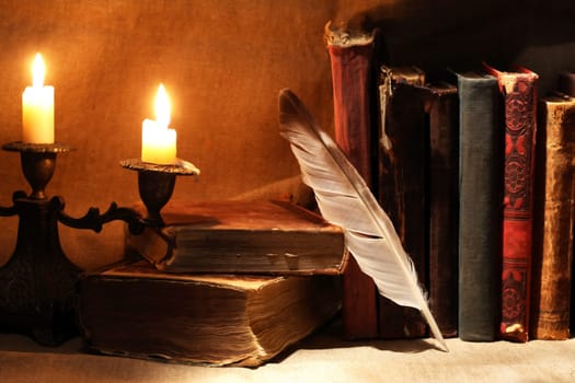 Nice vintage candlestick on background with old books