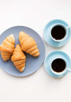 cup of coffee with croissant on white background.