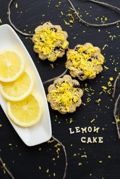 lemon cupcakes on a black background with lemon zest, lemon cake inscription