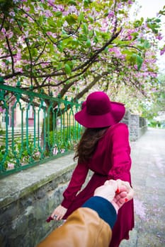 rear view - Woman holding the hand of man