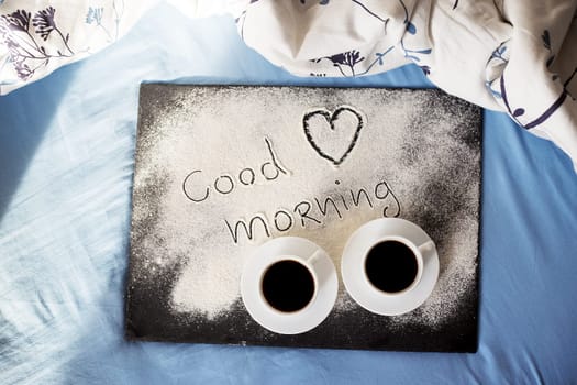 good morning inscription flour on a board with cups of coffee, heart Valentine's day.