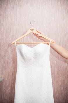 Modern white wedding dress hanging on the hanger