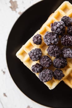 Delicious and beautiful Belgian waffles with blackberries.