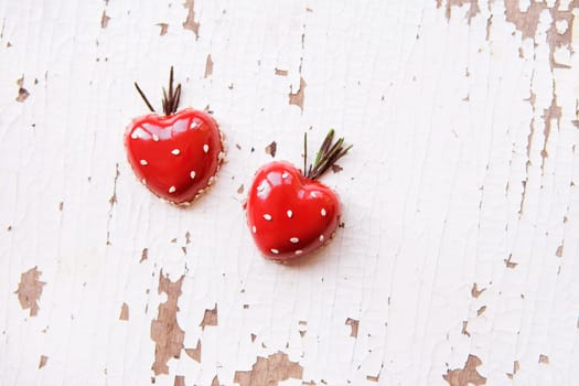 Beautiful and tasty dessert in the form of heart on an old wooden background, close-up.