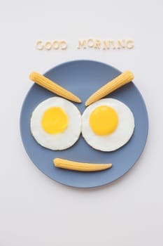 cheerful breakfast, two eggs on a plate, the inscription Good Morning