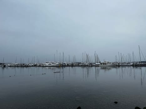 Sailboat reflections at Port Sidney Marina on a dreary dark and overcast day - Sidney, Vancouver Island, British Columbia, Canada
