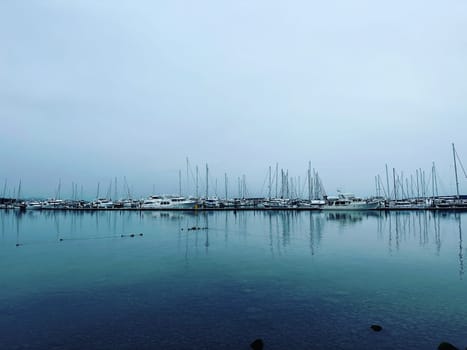 Sailboat reflections at Port Sidney Marina on a dreary dark and overcast day - Sidney, Vancouver Island, British Columbia, Canada