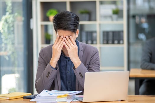 Young business man feeling tired stressed concern upset nervous serius in office, business employee exhausted sad disappointed frustrated burn out at desk. High quality photo