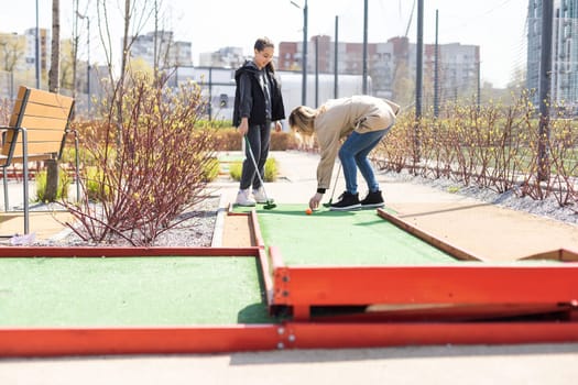 Family Time Playing Mini-Golf In The Summer.