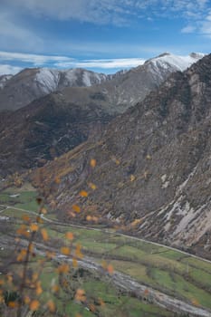 Snowy mountains under cloudy sky landscape in Boi Valley in Pyrenees in Catalonia