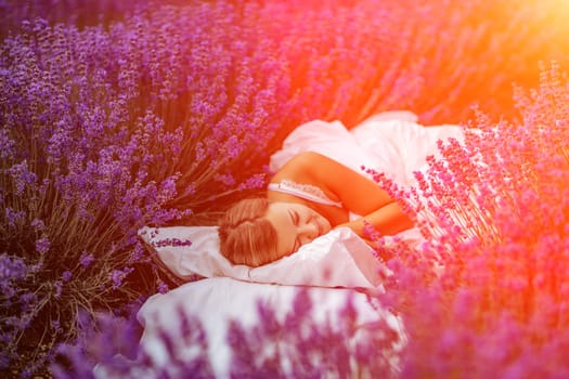 A middle-aged woman lies in a lavender field and enjoys aromatherapy. Aromatherapy concept, lavender oil, photo session in lavender.