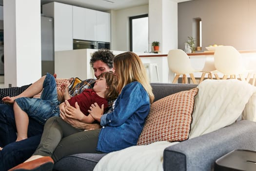 Family is a gift. an affectionate family of three relaxing on the sofa at home