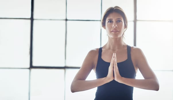 Yoga is a way to detox the mind. an attractive young woman practising yoga at home