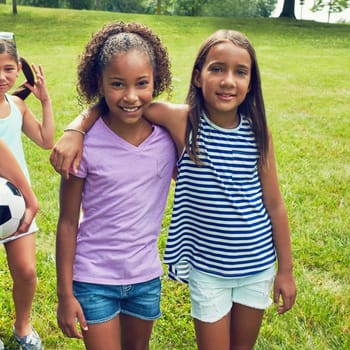 The best days are spent with the best of friends. two young girls hanging out with their friends in the park