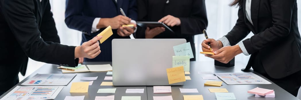 Analyst team use sticky note and laptop for financial insight with business Fintech paper for data analysis dashboard. Creative and analytic brainstorming for business marketing strategy idea. Prodigy
