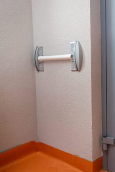 On the wall of the corridor partially installed wall bumper. Protection of the wall from damage.