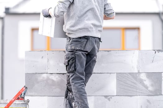 construction of a wall of a house made of concrete bricks. High quality photo