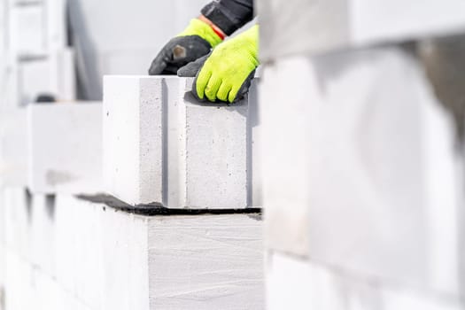 construction of a wall of a house made of concrete bricks. High quality photo