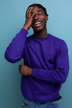 handsome african young guy with dreadlocks smiling and joking.